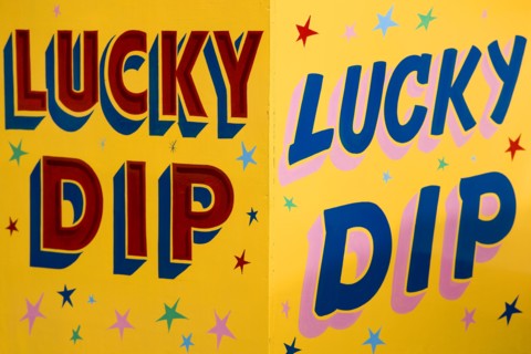 ENGLAND, West Sussex, Findon, Findon village Sheep Fair Colourful yellow sign for a Lucky Dip