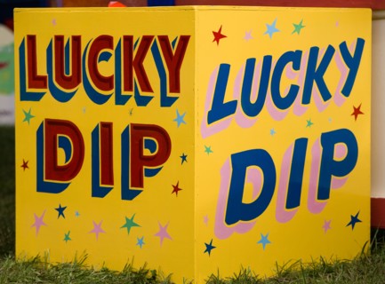 ENGLAND, West Sussex, Findon, Findon village Sheep Fair Colourful yellow sign for a Lucky Dip