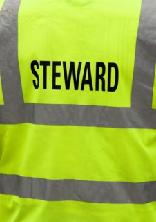 ENGLAND, West Sussex, Findon, Findon village Sheep Fair The reflective jacket of a Steward.