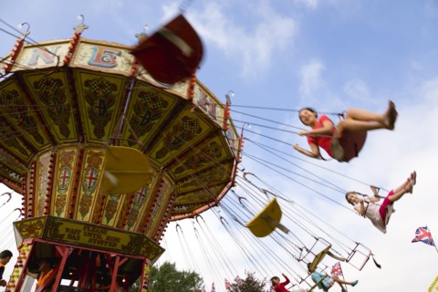 ENGLAND, West Sussex, Findon, Findon village Sheep Fair Children in motion riding on a swing