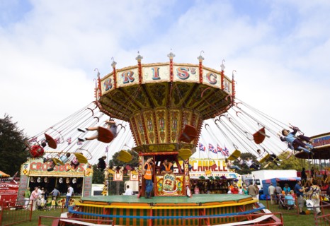 ENGLAND, West Sussex, Findon, Findon village Sheep Fair Children in motion riding on a swing