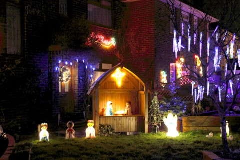 ENGLAND, West Sussex, Southwick, Cul de Sac of houses decorated with fairy lights for Christmas.