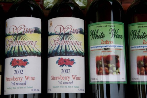 THAILAND, North, Chiang Mai, Samoeng. Close up of locally produced strawberry wine bottle labels.