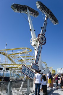 ENGLAND, East Sussex, Brighton, People watching the pendulum ride on Brighton Pier with the crowded