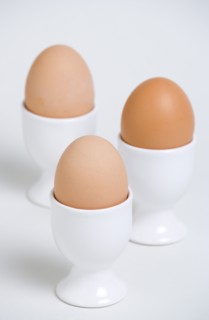 FOOD, Uncooked, Eggs, Three boiled free range eggs in egg cups.