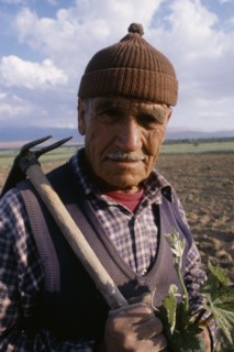 TURKEY  Antalya Portrait of farmer carrying hoe over his shoulder.EurasiaEuropean Middle East