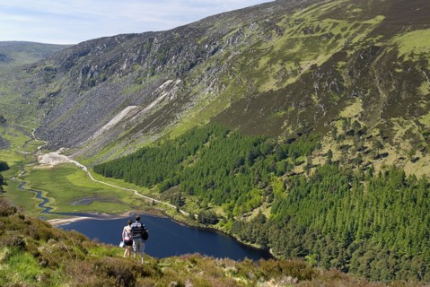 IRELAND, County Wicklow, Glendalough, A couple enjoy the view over the Upper Lake from the Spink