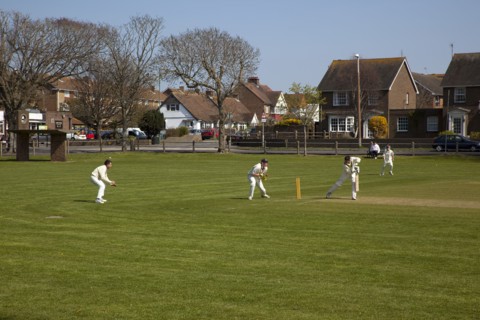 England, West Sussex, Southwick, Local Cricket team playing on village green.
