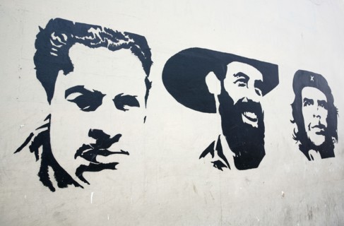 Cuba, Havana, Centro Habana, Painting of Che Guevara along with two other portraits on a wall.