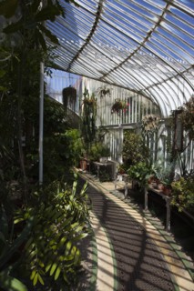 Ireland, Northern, Belfast, Botanic Gardens with people sat on benches outside the Palm House next