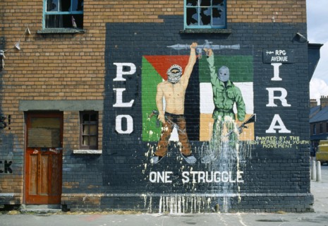 Ireland, North, Belfast, PLO IRA Irish Republican mural on the side of a terrace house on the corner with Falls Road