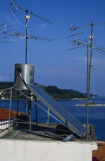 Environment, Energy, Solar Power, Solar power panel amongst aerials on the roof of a house in