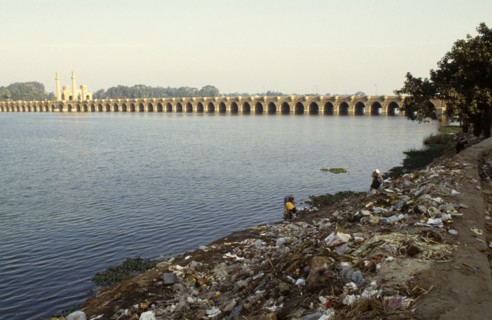Environment, Litter, View over people doing washing on the litter scattered banks of the Nile