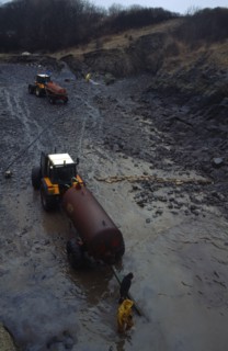 Wales, Dyfed, Stackpole Quay, Workers clearing beached oil from grounded tanker the Sea Empress in