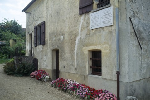 France, Ile de France, Coupvray, Marble commemorative plaque under a shuttered window on the wall