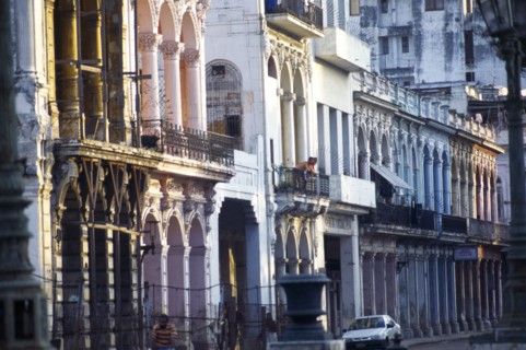 CUBA, Old Havana, Crumbling exterior facades of old houses painted in pastel colours lining street.