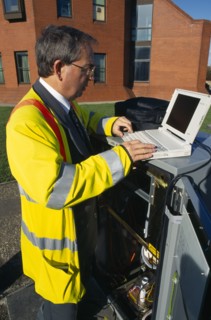 England, West Sussex, Shoreham-by-sea, IT Technician programming traffic lights signal box from a