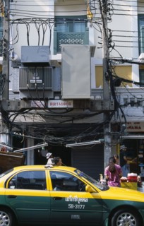 Thailand, Bangkok, Khao San Road, Overhead lectricity cables and transformers above pavement