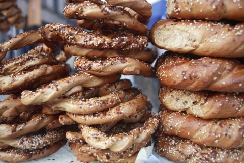 Poland, Krakow, Obwarzaneck,twisted rings of bread strewn with poppy sale for sale from street