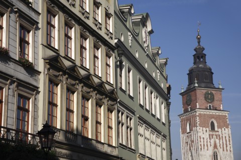 Poland, Krakow, Old Town Hall & pastel coloured buildings in the Rynek Glowny market square.