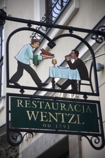 Poland, Krakow, sign for Restaurant Wentzl in the old city.