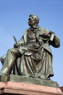 Poland, Wroclaw, seated statue of writer Alexander Fredo in the Rynek old town square.