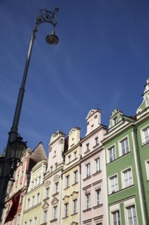 Poland, Wroclaw, pastel coloured building facades & street light in the Rynek old town square.