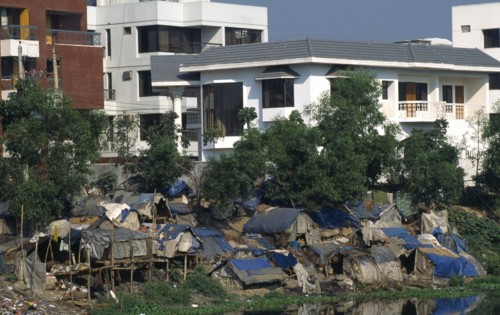 Bangladesh, Dhaka, Slum dwellings with expensive apartments behind.