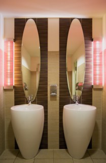 GERMANY, Saxony, Dresden, Washroom in restaurant with two washbasin sinks and matching mirrors.