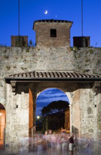 ITALY, Tuscany, Pisa, The Campo dei Miracoli or Field of Miracles.The west entrance gate at dusk