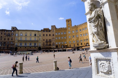 ITALY, Tuscany, Siena, A religious carving on the entrance portico of the Gothic Palazzo Publico