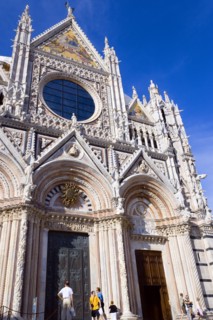 ITALY, Tuscany, Siena, The pink  black and white marble facade of the Duomo cathedral church of