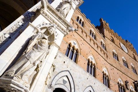 ITALY, Tuscany, Siena, Religious carvings on the portico entrance and facade of the Palazzo Publico