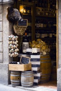 ITALY, Tuscany, Siena, Shop doorway display of Chianti wines and pasta with a stuffed wild boar