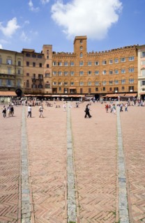 ITALY, Tuscany, Siena, The Piazza del Campo and surrounding buildings with tourists walking in the