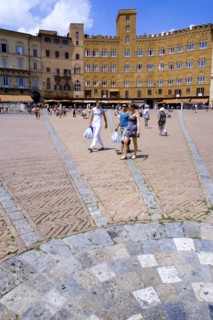 ITALY, Tuscany, Siena, The Piazza del Campo and surrounding buildings with tourists walking in the