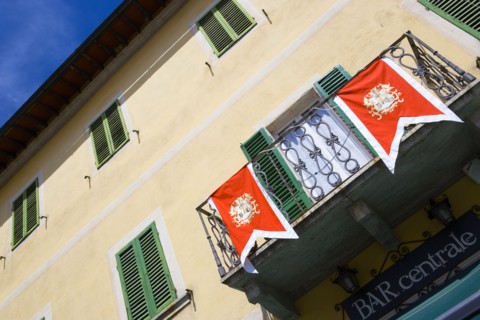 ITALY, Tuscany, San Quirico D'Orcia, Shuttered window facade and balcony of the Bar Centrale in the