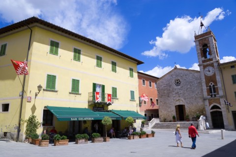 ITALY, Tuscany, San Quirico D'Orcia, Red and white flags of the Castello Quartieri or quarter