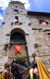 ITALY, Tuscany, San Gimignano, Medieval costumed procession pageant through the streets passing in