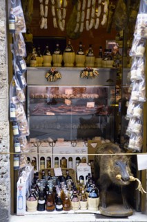 ITALY, Tuscany, San Gimignano, Shop display of chianti wines and wild boar products with a stuffed