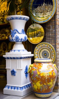 ITALY, Tuscany, San Gimignano, Colourful glazed local ceramics displayed in a shop doorway.