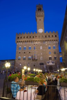 ITALY, Tuscany, Florence, People dining at restaurant tables outdoors at night in the Piazza della