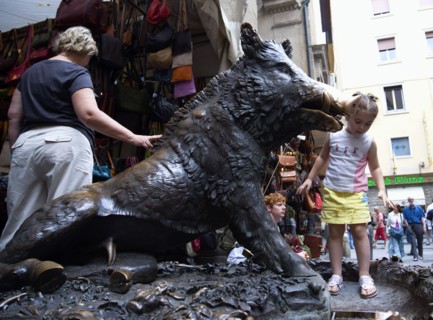 ITALY, Tuscany, Florence, People by the 17th century bronze fountain called Il Porcellino in the