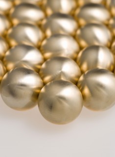 Industry, Machinery, Components, Brass metal lathe turned ball bearings.