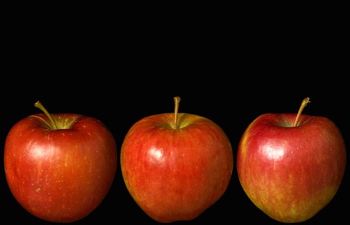 Food, Fruit, Apples, Three ripe red apples in a line against a black background.