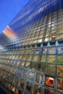 Japan, Honshu, Tokyo, Ginza, nightime view of the glass block facade of the Hermes Building.