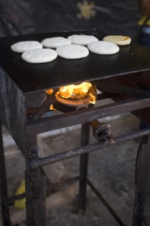 VENEZUELA, Bolivar State, Ciudad Bolivar, Handmade pancakes on a metal big plate with fire