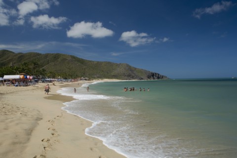 VENEZUELA, Margarita Island, Playa Caribe, View of exotic beach with people swimming and walking on