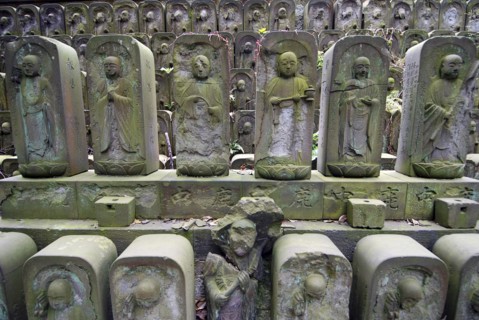 Japan, Tokyo, Nippori, Jyomo-in shrine, dozens of stone Jizo statues of the Buddha.