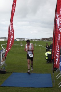 England, West Sussex, Goring-by-Sea, Worthing Triathlon 2009, male competitor checking his watch at